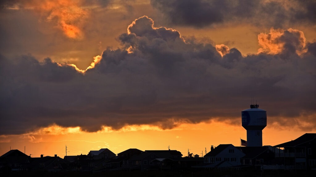 Sun sets over cottages and beach homes along the dunes at Atlantic Beach.