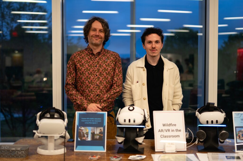 Douglas Hamilton and Ethan Brain stand behind their booth
