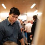 Camilo Rey-Sanchez listening to a visitor