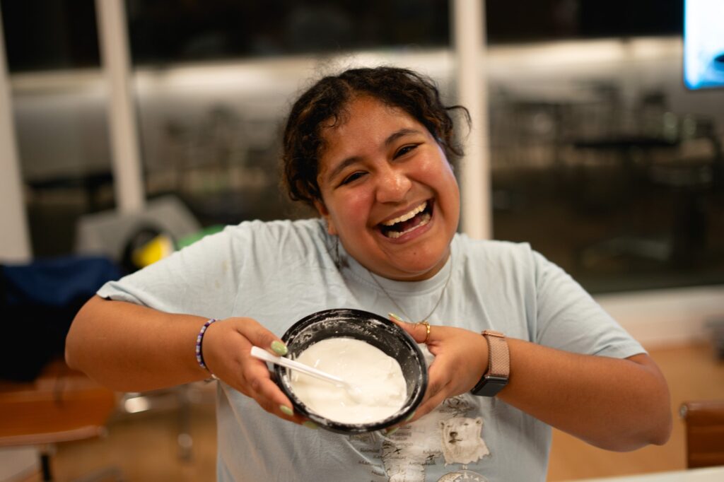 Tia Ogus holds a container of paste