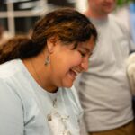 Tia Ogus smiling while engaging with visitors