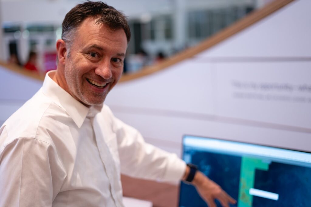 Karl Wegmann pointing at computer screen