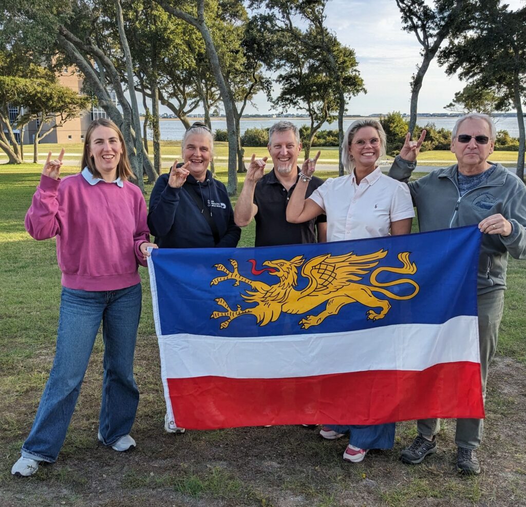 Leonie Kandler, Regine Labrenz, Chris Osburn, Sabine  Brüser and Ralf Prien hold the Rostock flag